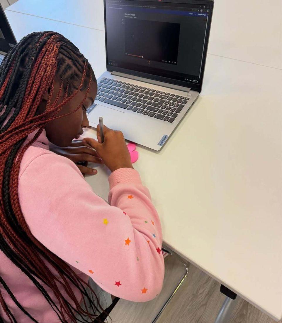 A student working through online coursework at a laptop
